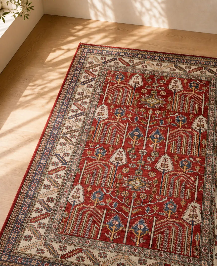 Decorative Afghan rug with intricate patterns on a wooden floor