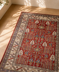Decorative Afghan rug with intricate patterns on a wooden floor