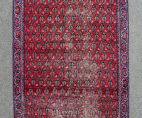Red Persian Shiraz runner rug detailed tribal pattern close-up