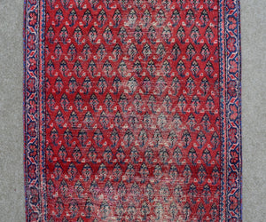 Red Persian Shiraz runner rug detailed tribal pattern close-up