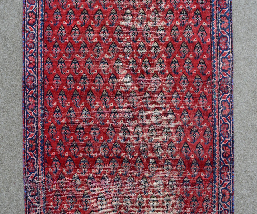 Red Persian Shiraz runner rug detailed tribal pattern close-up