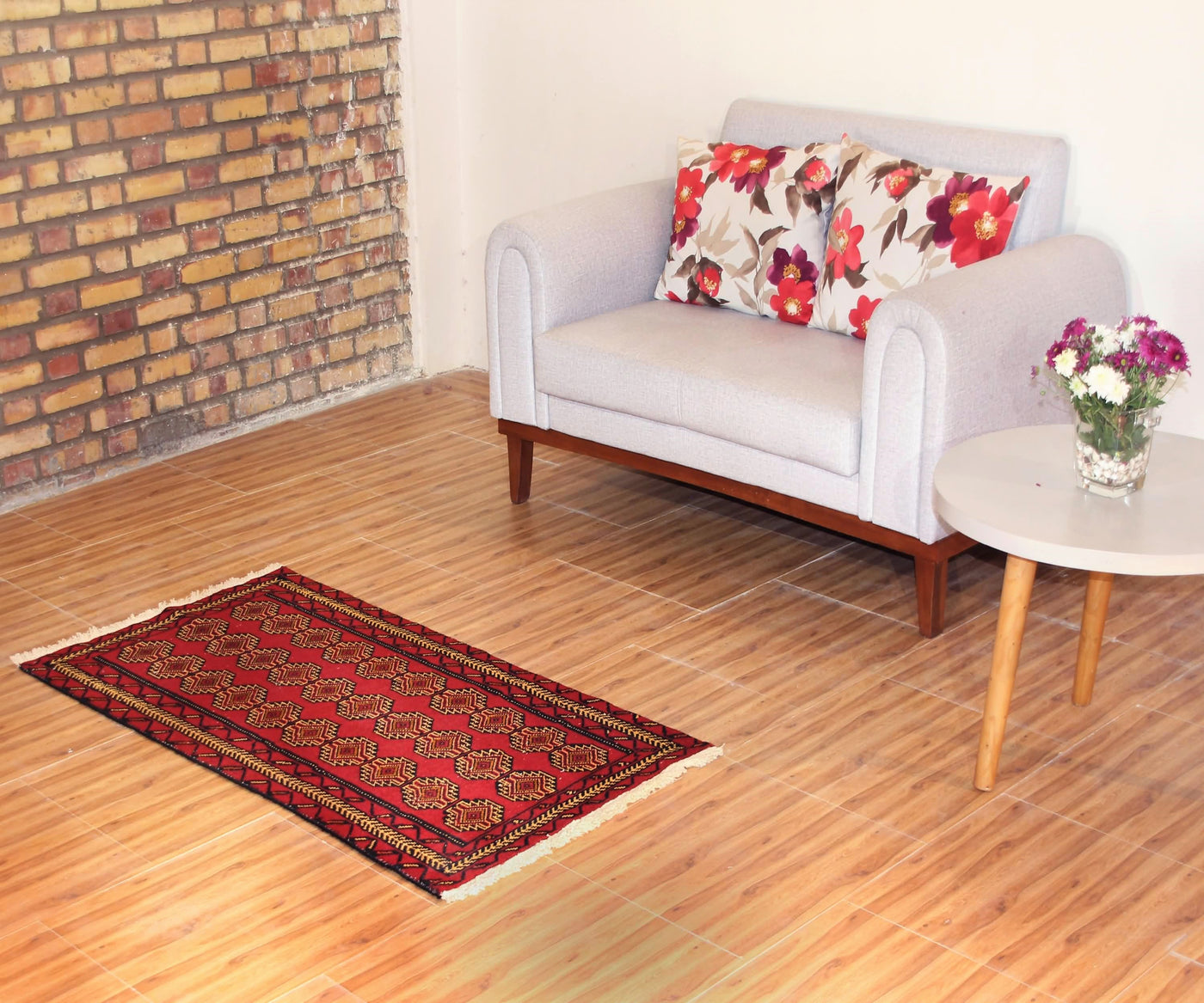 Turkmen tribal runner rug styled in interior setting with bold red and black geometric design
