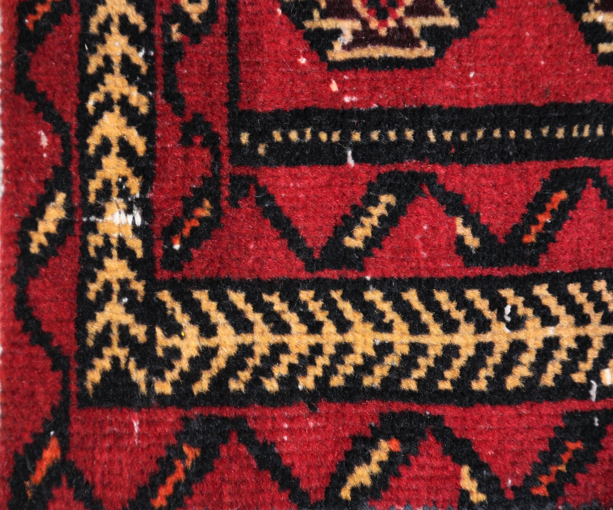 Border detail of hand knotted Turkmen rug with angular tribal guard stripes and bold contrast pattern
