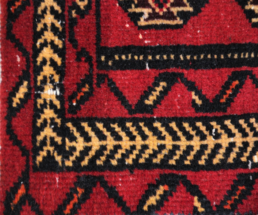 Border detail of hand knotted Turkmen rug with angular tribal guard stripes and bold contrast pattern
