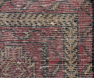Backside of vintage Turkmen Persian runner rug showing dense hand knotted weave and wool foundation
