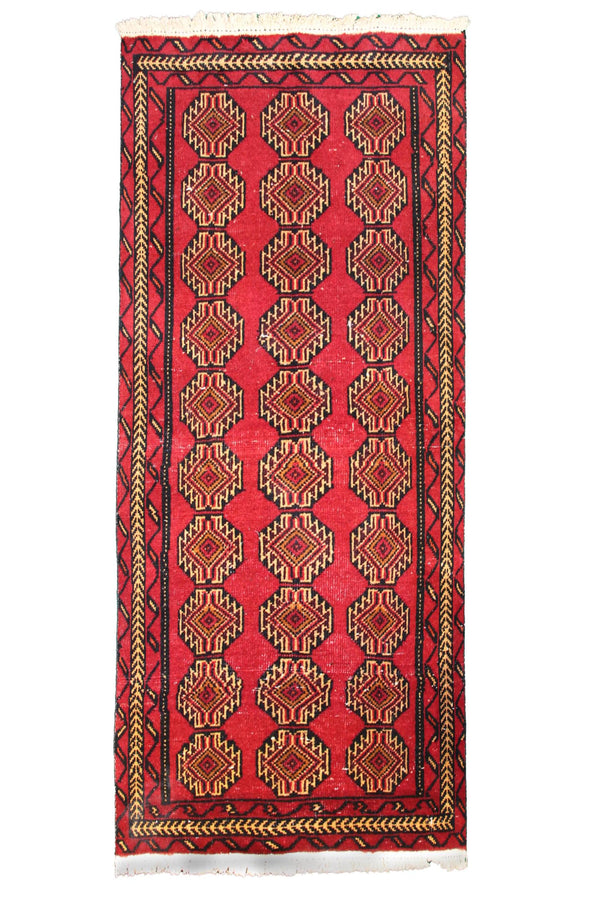 Hand knotted vintage Turkmen Persian runner rug with rich red tribal gul pattern
