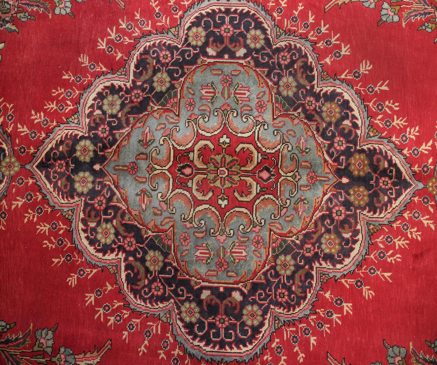 Close-up of Tabriz Persian rug central medallion with intricate floral arabesque pattern
