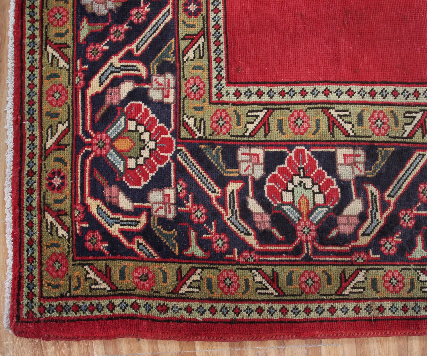 Detailed border view of vintage Tabriz rug featuring classic floral guard stripes and geometric accents
