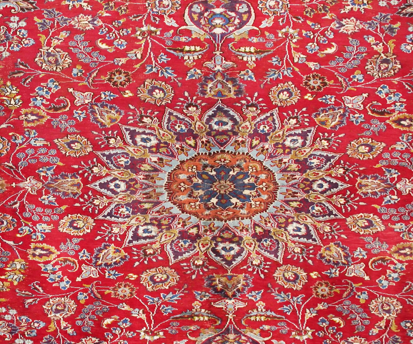 Close-up of Mashad Persian rug central medallion featuring detailed floral arabesque pattern
