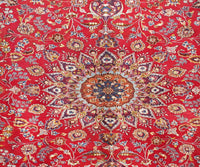 Close-up of Mashad Persian rug central medallion featuring detailed floral arabesque pattern
