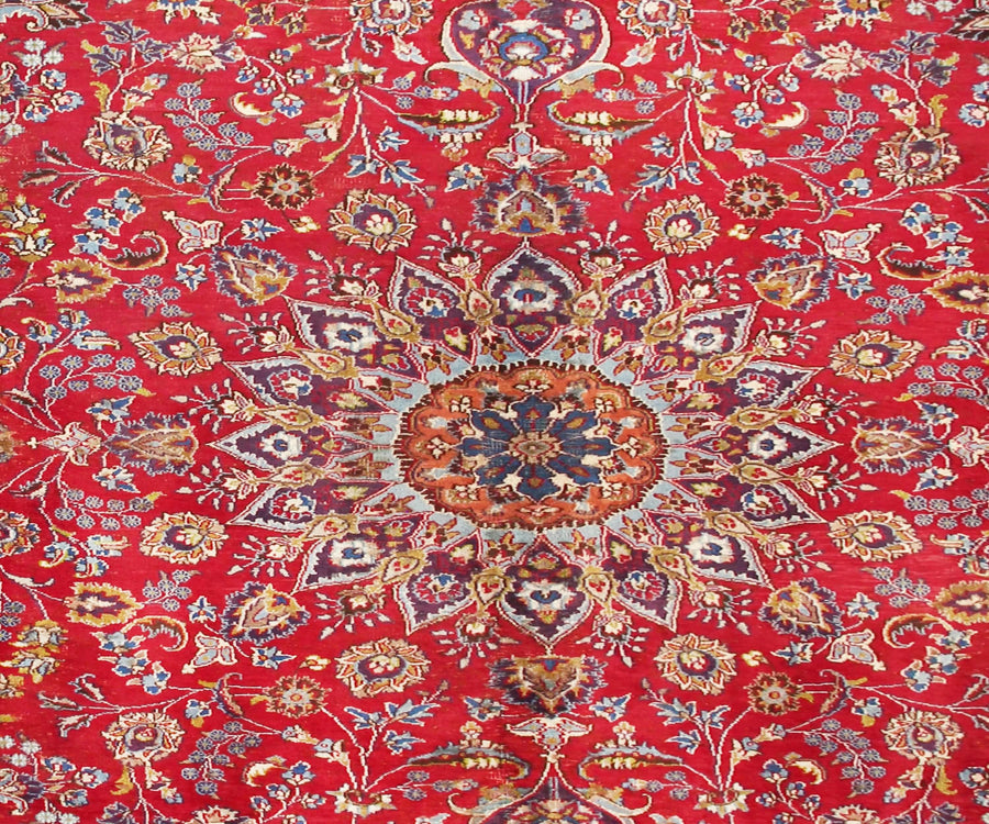 Close-up of Mashad Persian rug central medallion featuring detailed floral arabesque pattern
