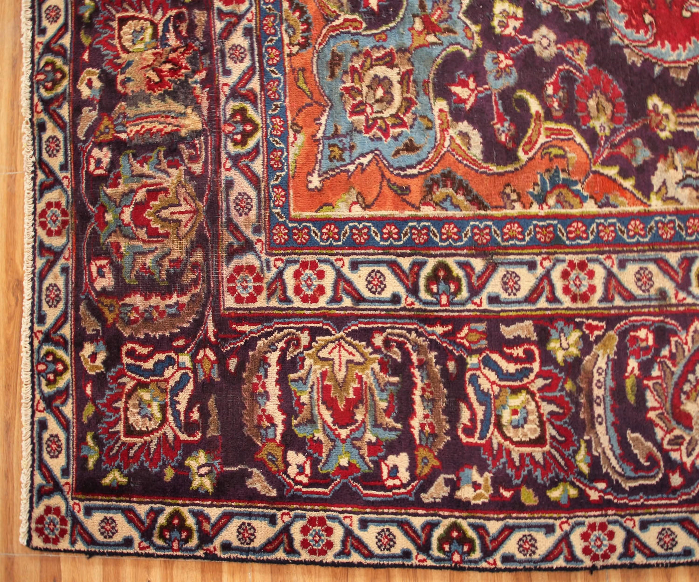 Border detail of hand knotted Mashad Persian rug with layered floral guard stripes and intricate motifs

