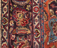 Corner detail of vintage Mashad Persian rug showing classic floral pattern and decorative framing border
