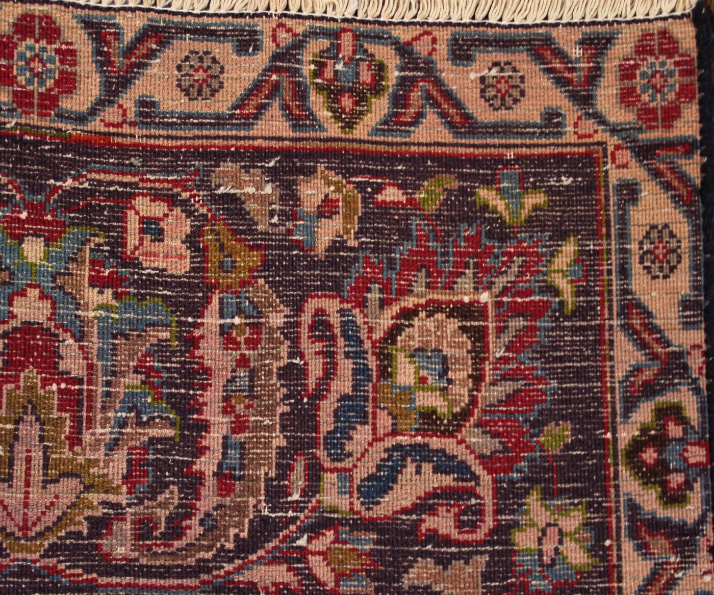 Backside of hand knotted vintage Mashad Persian rug showing fine weave density and traditional wool foundation
