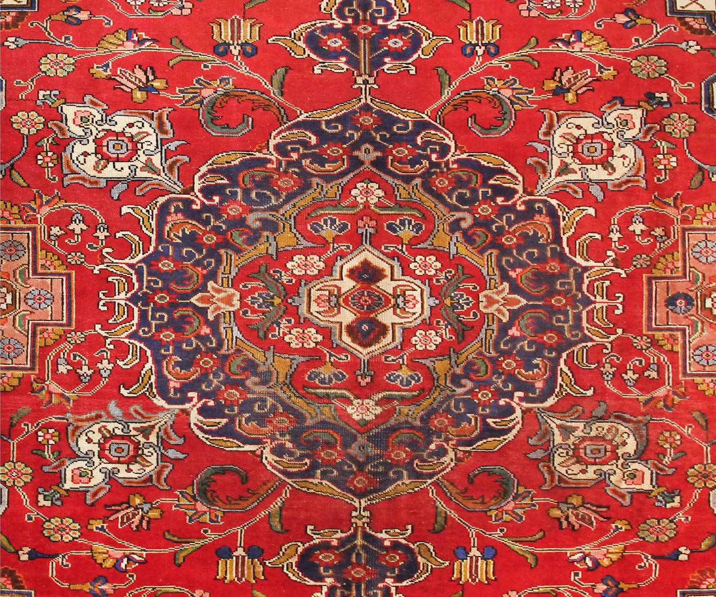 Close-up of Tabriz Persian rug central medallion with refined floral detailing and symmetrical layout
