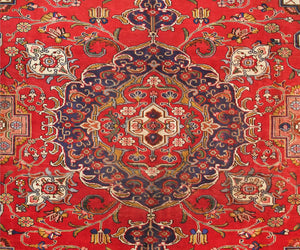 Close-up of Tabriz Persian rug central medallion with refined floral detailing and symmetrical layout

