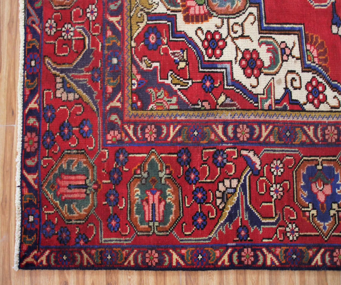 Detailed border view of vintage Tabriz rug with classic floral guard stripes and decorative motifs
