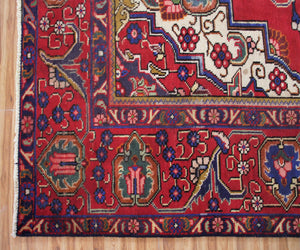 Detailed border view of vintage Tabriz rug with classic floral guard stripes and decorative motifs

