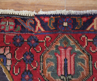 Corner detail of hand knotted Tabriz Persian rug highlighting intricate floral pattern and framing border
