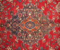 Vintage Mashad rug featuring elaborate medallion and dense floral vine motifs in red, navy and ivory tones
