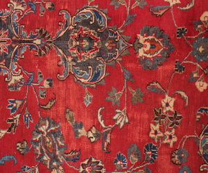 Close-up of Mashad Persian rug central medallion with detailed floral arabesque design

