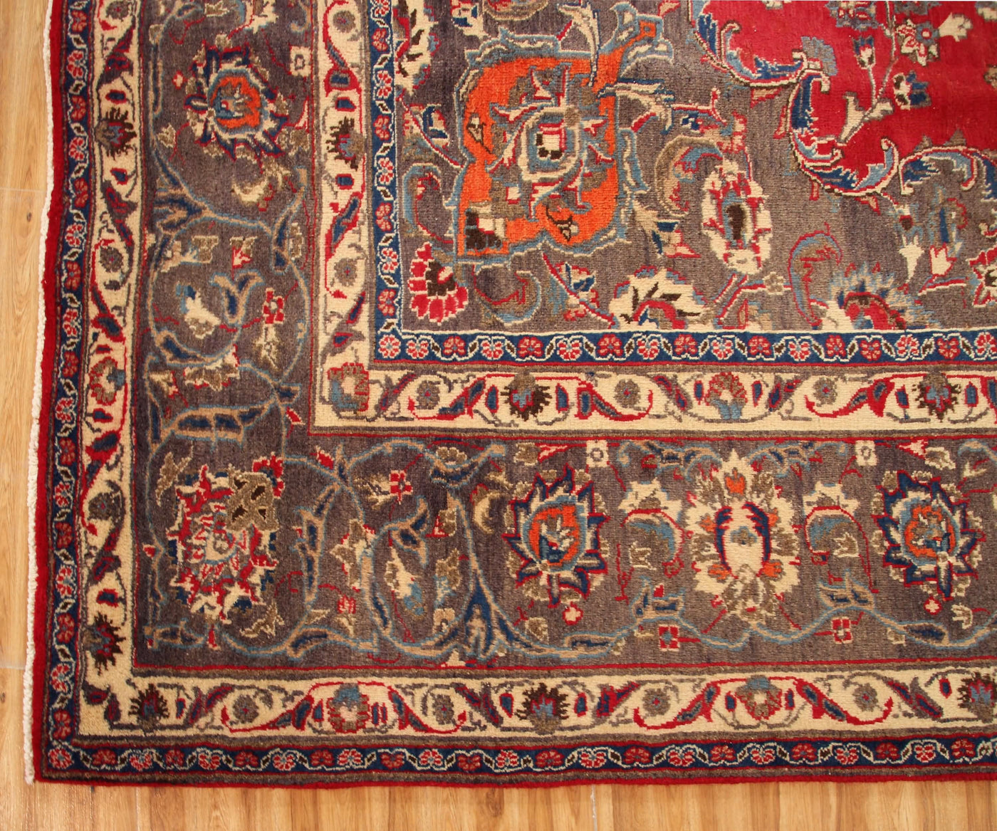 Ornate border detail of hand knotted Mashad Persian rug with layered floral guard stripes
