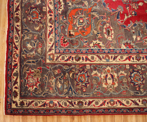 Ornate border detail of hand knotted Mashad Persian rug with layered floral guard stripes
