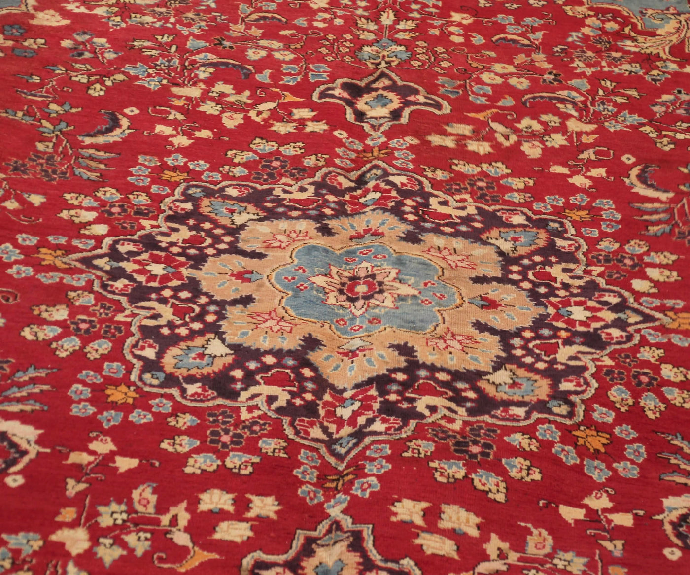 Close-up of Sabzevar Persian rug central medallion with detailed floral arabesque pattern
