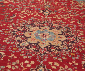 Close-up of Sabzevar Persian rug central medallion with detailed floral arabesque pattern
