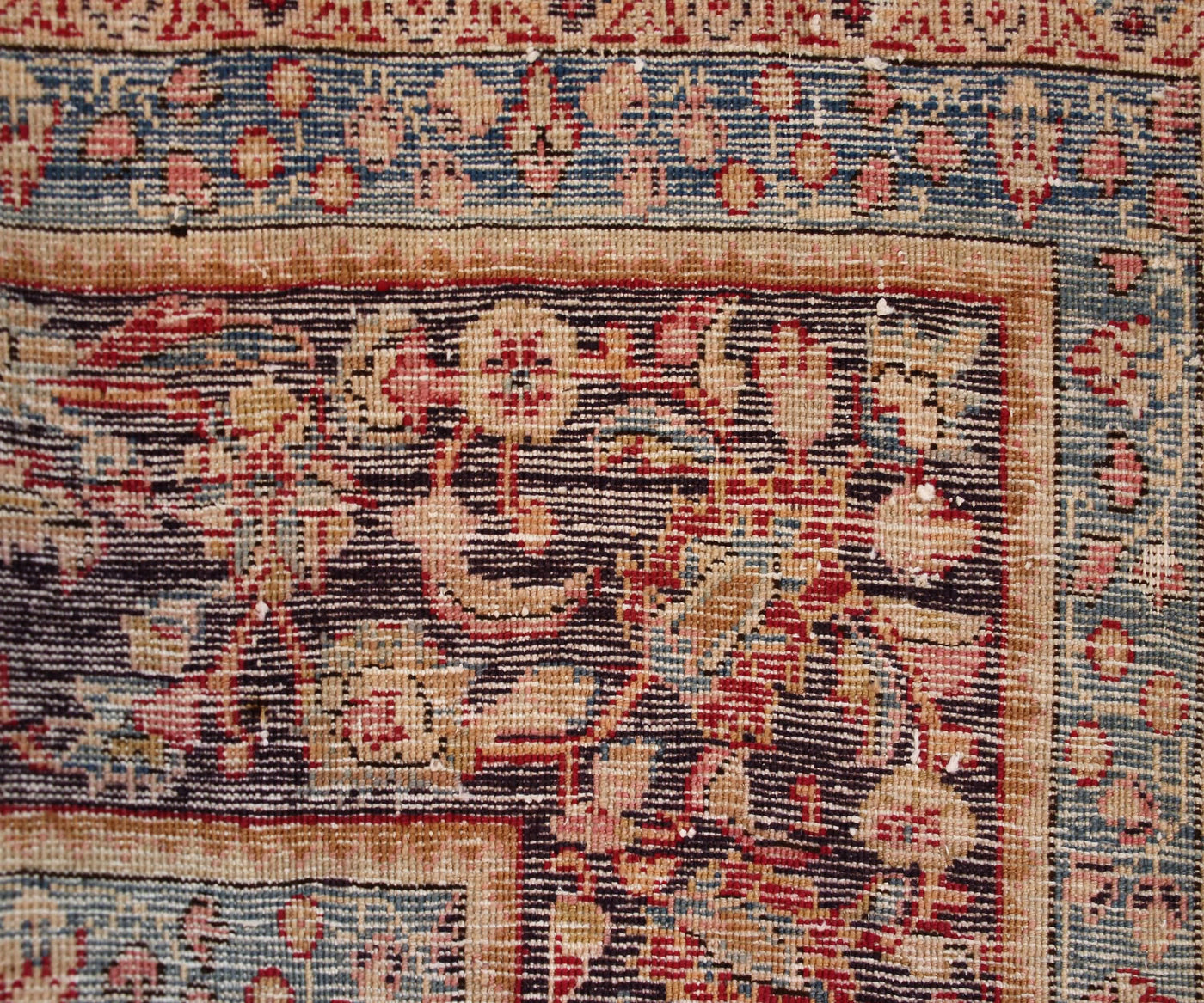 Backside of hand knotted antique Sabzevar Persian rug showing fine weave density and traditional wool foundation
