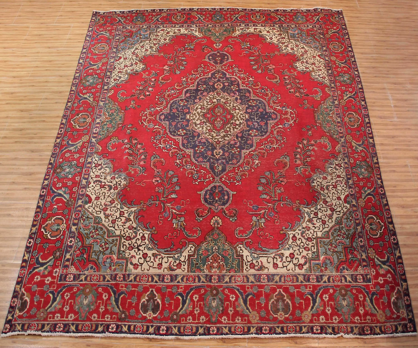 Large antique Tabriz Persian rug 296x385 cm full view showing intricate floral design and elegant corner spandrels
