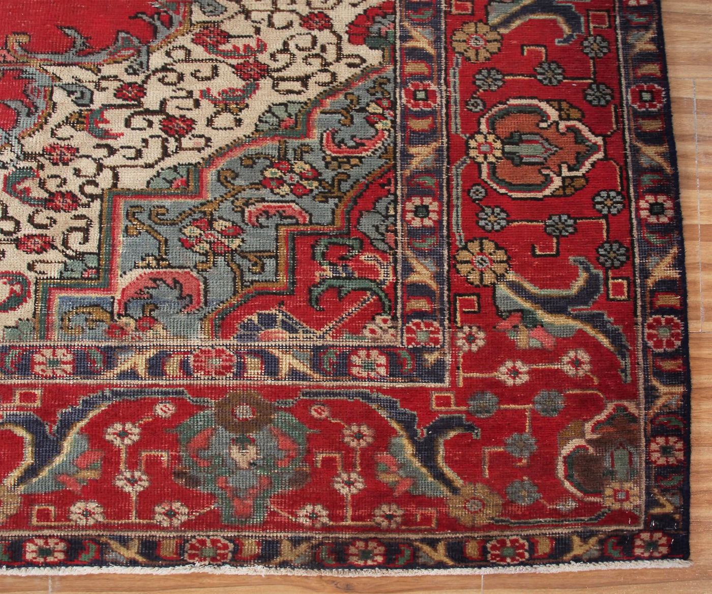 Detailed border view of antique Tabriz Persian rug with refined floral guard stripes and decorative accents
