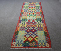 Chobi kilim runner 83x385 cm full view showing vibrant tribal motifs in red, green, yellow and blue
