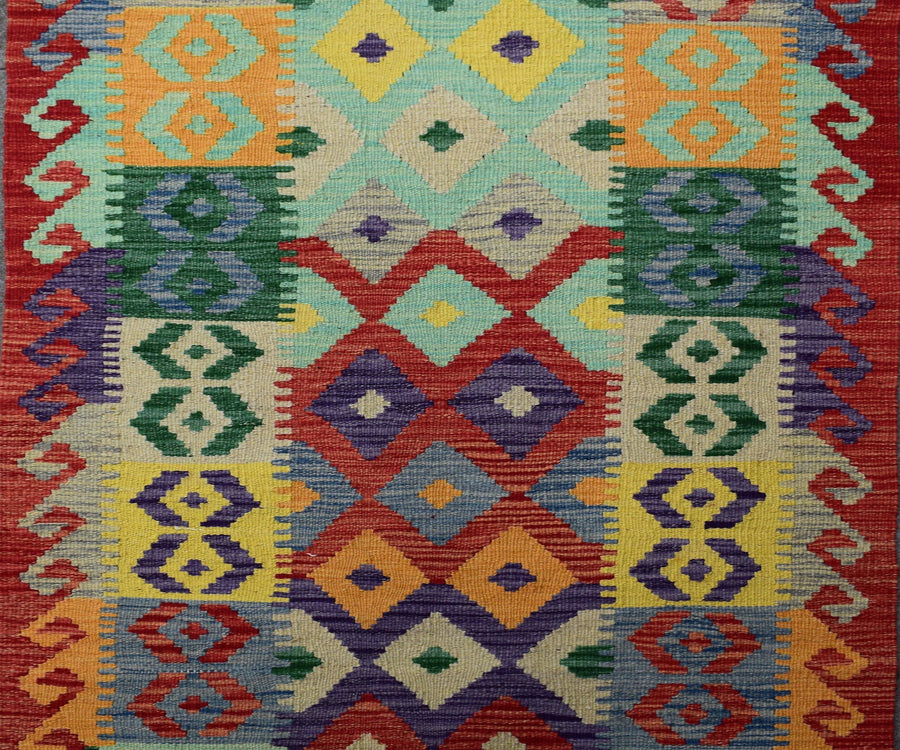 Close-up of Chobi kilim runner showing detailed flatweave texture and bold tribal diamond motifs
