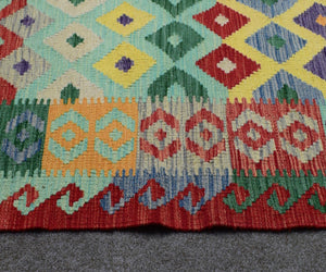 Kilim runner border detail with zigzag tribal guard stripes and multicolor woven design
