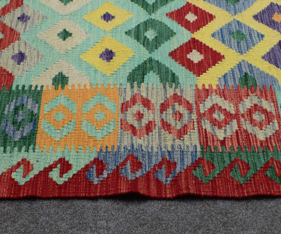 Kilim runner border detail with zigzag tribal guard stripes and multicolor woven design
