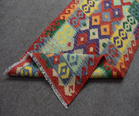 Folded view of Chobi kilim runner showing authentic flatwoven construction and fringe detail
