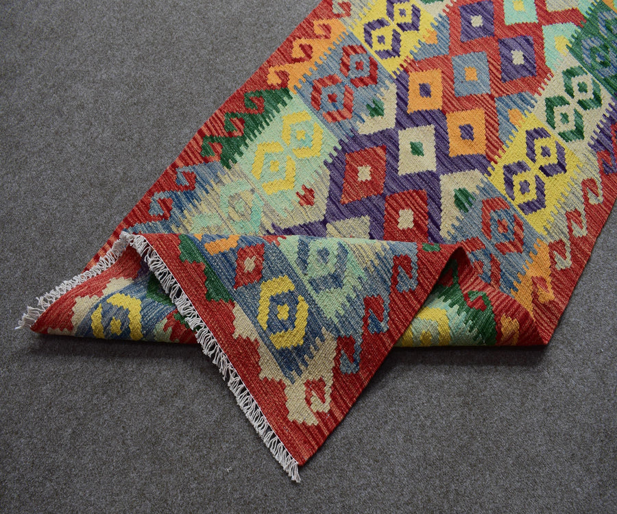 Folded view of Chobi kilim runner showing authentic flatwoven construction and fringe detail
