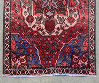 Hand knotted Shiraz runner rug border detail red and navy