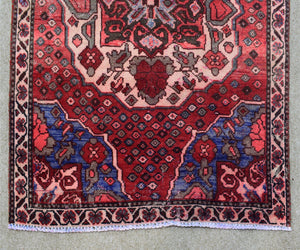 Hand knotted Shiraz runner rug border detail red and navy