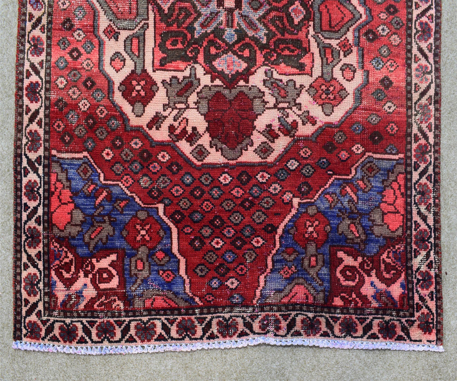 Hand knotted Shiraz runner rug border detail red and navy