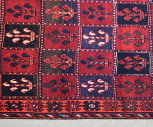 Traditional Shiraz Persian rug pattern with tribal motifs and deep red colors