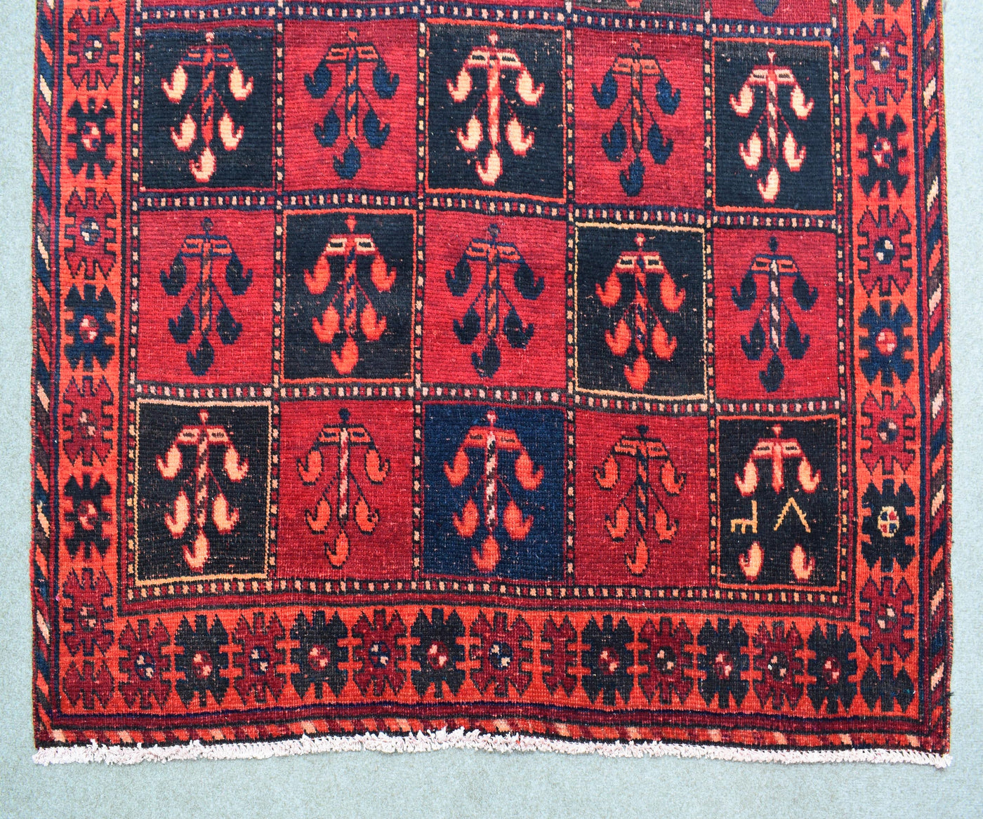 Detailed view of hand knotted Persian Shiraz rug showing intricate tribal design