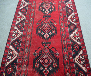 Vintage Shiraz Persian rug with classic tribal medallion design in deep red tones