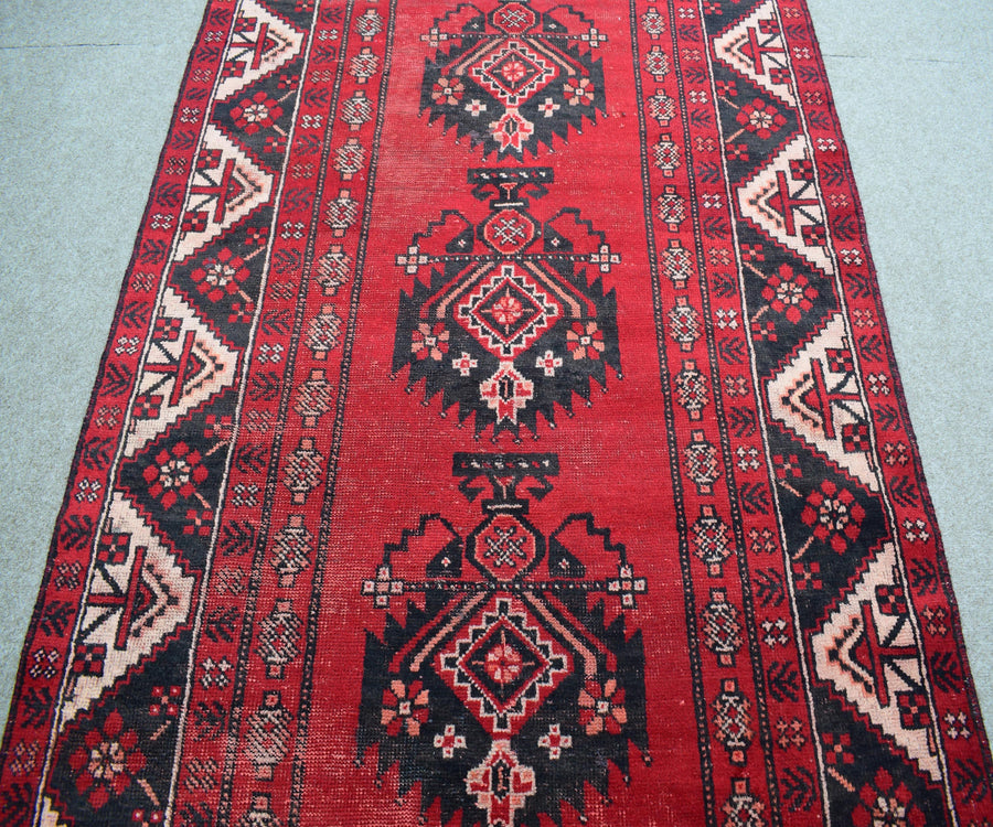 Vintage Shiraz Persian rug with classic tribal medallion design in deep red tones