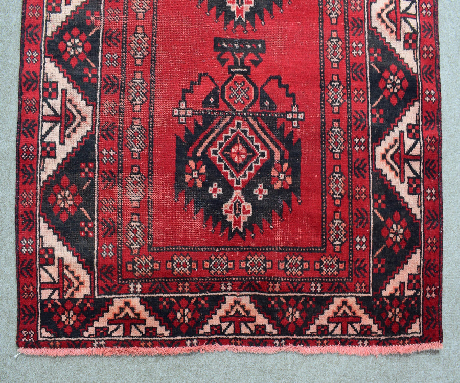 Detailed view of antique Shiraz rug central medallion and geometric pattern
