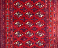 Close-up of vintage Persian Shiraz rug showing detailed diamond medallions and rich red wool field