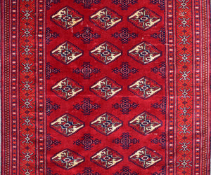 Close-up of vintage Persian Shiraz rug showing detailed diamond medallions and rich red wool field