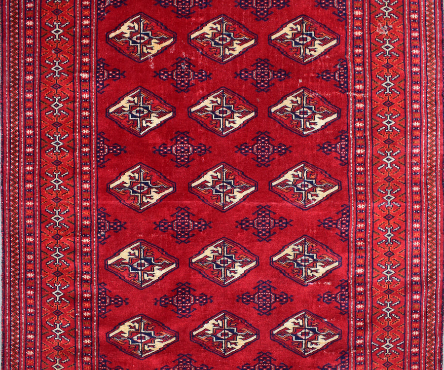 Close-up of vintage Persian Shiraz rug showing detailed diamond medallions and rich red wool field