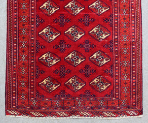 Detailed view of vintage Shiraz rug central diamond medallion pattern in red, navy and ivory tones